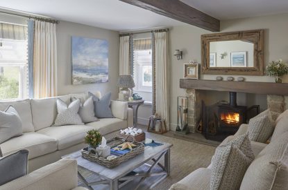 The living room with a log burner at The Beach House, Devon
