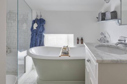 A bathroom with roll top bath at The Beach House, Devon