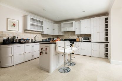 The kitchen with an island at Rose Cottage, Isle of Wight