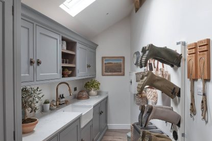 A utility room with boot stand at Beatrix Cottage, Lake District