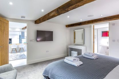 The bedroom with ensuite at The Shippon Cottage, Lake District