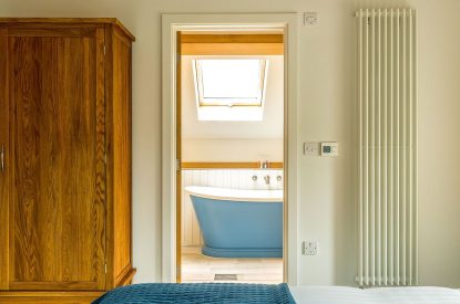 A bedroom with ensuite at The Old Grain Store, Lake District