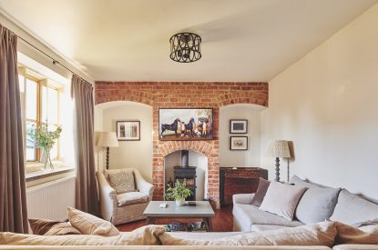 The lounge with log burner at Ember Cottage, Cotswolds