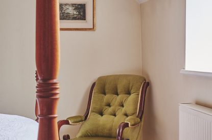 An armchair in the bedroom at Hardy Cottage, Cotswolds