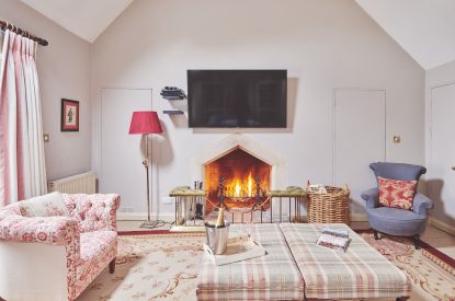 The living room with fireplace at Carroll Cottage, Cotswolds