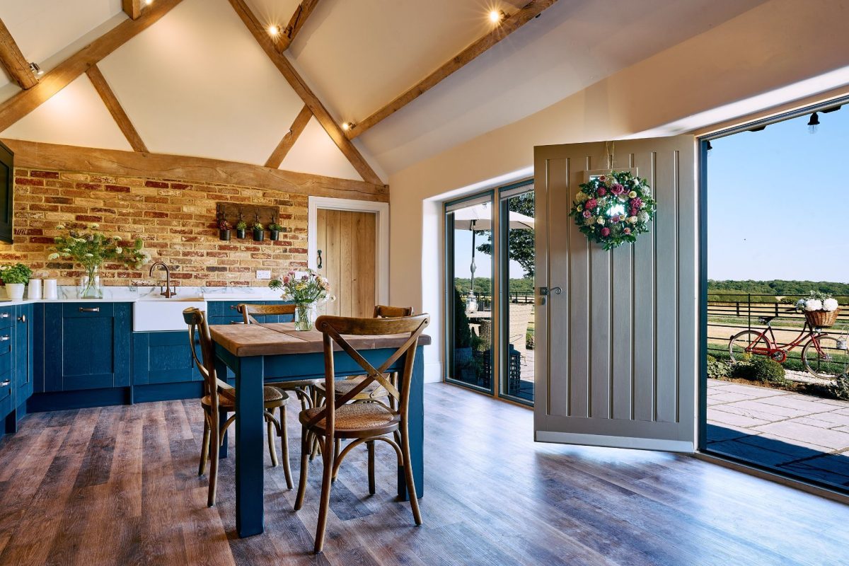 The front door, kitchen and dining table in Stable Barn, Cotswolds