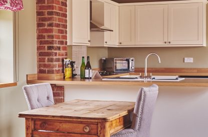 The two-seater dining table and chairs at The Dairy Barn, Worcestershire 