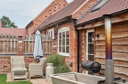The wood-fired Swedish Hikki hot tub in the private garden at The Dairy Barn, Worcestershire 