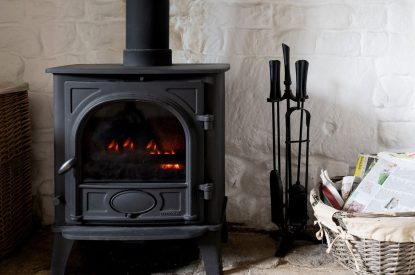 The wood-burning stove in the reception room at Fig Tree Cottage