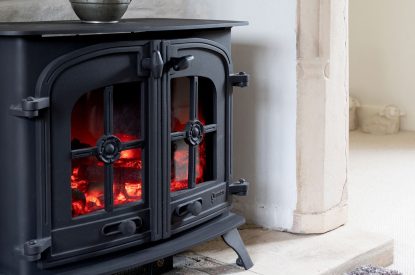 The electric fireplace in the sitting room at Fig Tree Cottage, Cotswolds
