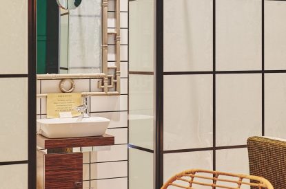 A dining chair and the entrance to the en-suite at Muscari Cottage, Vale of Glamorgan