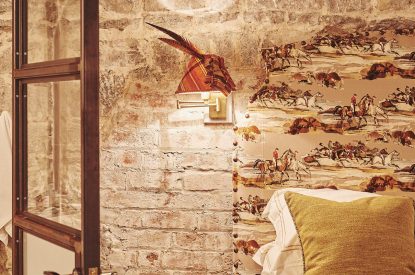 Bedroom accessories against the exposed brick walls at Fritillaria Cottage, Vale of Glamorgan