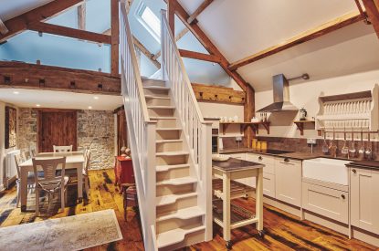 The kitchen and staircase to the mezzanine level at Lotus Cottage, Vale of Glamorgan