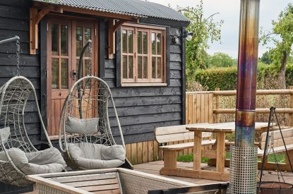 The egg chairs, outdoor dining table and wood-fired Swedish Hikki hot tub at The Hangout Hut, Worcestershire 
