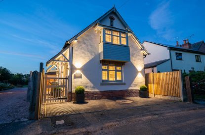 The exterior of the cottage at night at Pilgrim Cottage, Cheshire