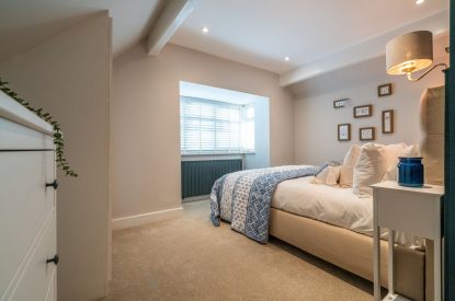 The master bedroom with a double bed at Pilgrim Cottage, Cheshire