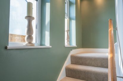Two arched windows in the hallway at Pilgrim Cottage, Cheshire