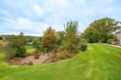 The private lawned garden and fire pit at Tinkers Folly, Yorkshire