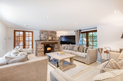 The living room with a log-burning stove at Rose Walls, Lake District