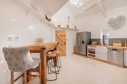 The kitchen bar with cushioned stools at Rose Walls, Lake District