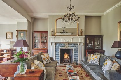 The living room with log burner at Roupel Hall, Devon