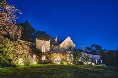 The exterior at night of Roupel Estate, Devon