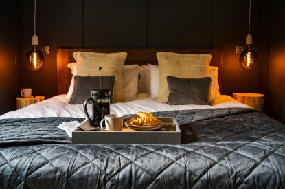 A double bed at Padstone Farmhouse, Cornwall