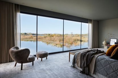 The master bedroom with lake view at The Reserve, Cotswolds