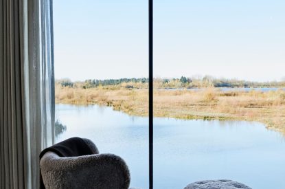 The master bedroom with lake view at The Reserve, Cotswolds