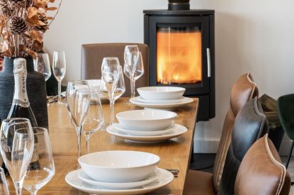 The dining room with log burner at Porthleven View, Cornwall