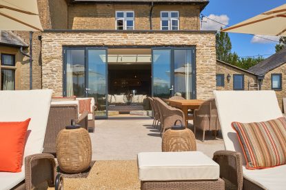 The patio with sun loungers at Lakeside Manor, Cotswolds