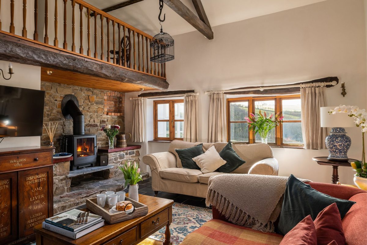 The living room with log burner at Honey Buzzard Farmhouse, Devon
