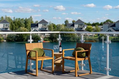 A sitting area on the balcony at Lakefront Lodge, Cotswolds