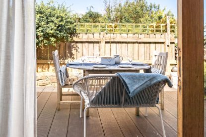 The patio with a dining table at Chapel Cottage, Pembrokeshire