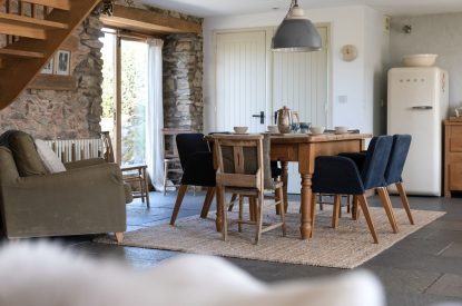 The dining table with French doors onto the patio at Chapel Cottage, Pembrokeshire