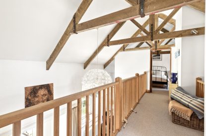 The upstairs hallway with oak beams at Chapel Cottage, Pembrokeshire