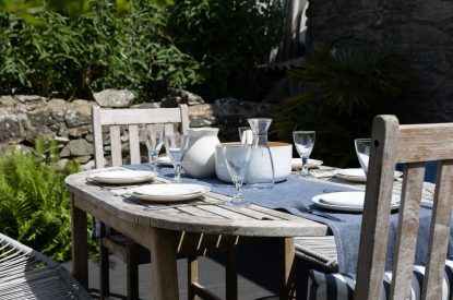 An outdoor dining table in the garden at Chapel Cottage, Pembrokeshire
