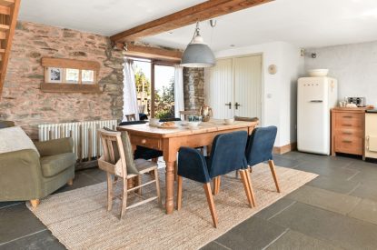 The dining room with doors onto the patio at Chapel Cottage, Pembrokeshire