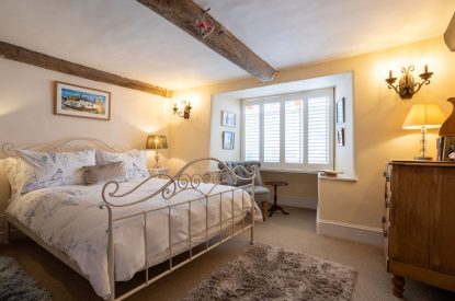 A double bedroom with a window seat at Sweet Shop Cottage, Somerset