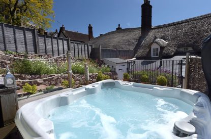 The garden with a hot tub at Sweet Shop Cottage, Somerset