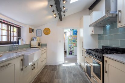 The galley kitchen leading to the hallway at Sweet Shop Cottage, Somerset