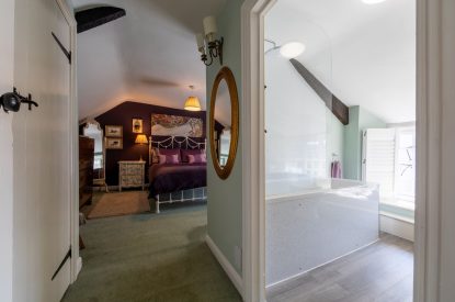 A double bedroom with an ensuite at Thatch Corner, Somerset