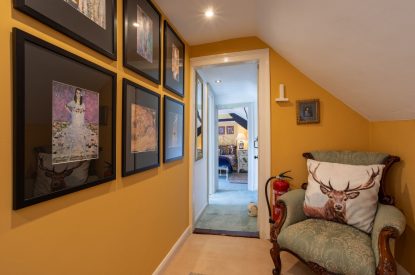 The hallway with an arm chair at Thatch Corner, Somerset