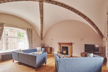 The living room with a log burner at The Tower, Scottish Borders