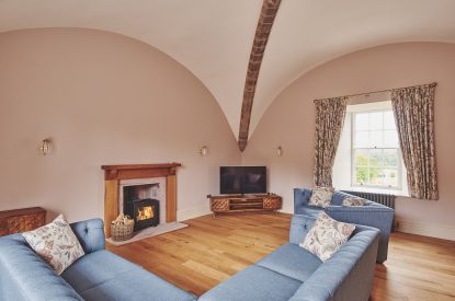 The living room with a log burner at The Tower, Scottish Borders