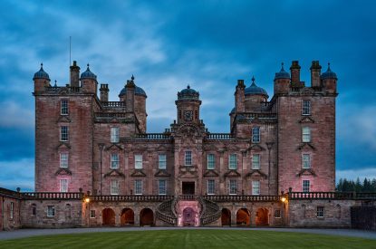 Drumlanrig Castle at dusk at Tower, Scottish Borders