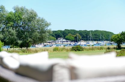 The outdoor seating area with views across the harbour at Brickworks and Vines, Isle of Wight