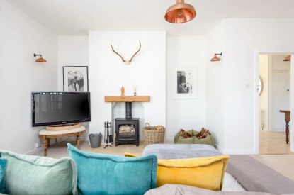 The living room with a log burner at Brickworks and Vines, Isle of Wight