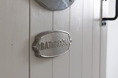 The bathroom door sign at Farmyard Cottage, Wiltshire