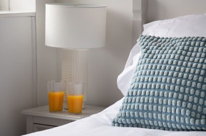 Orange juice on the bedside table at Farmyard Cottage, Wiltshire